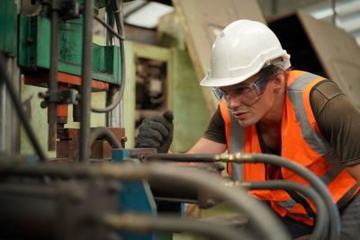 Side view of man working in factory