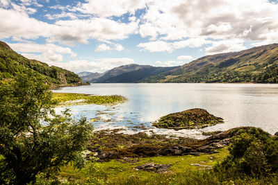 Scenic view of lake and mountains against sky