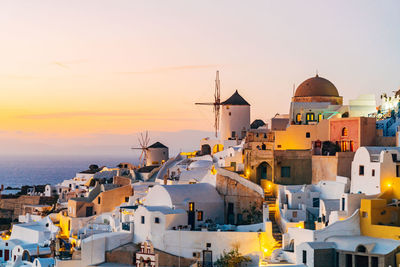 Buildings in city at sunset