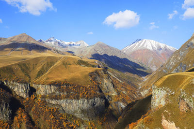 Scenic view of mountains against blue sky