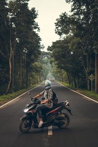 Motorcycle riding bicycle on road in city
