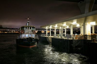 Boats in river with city in background