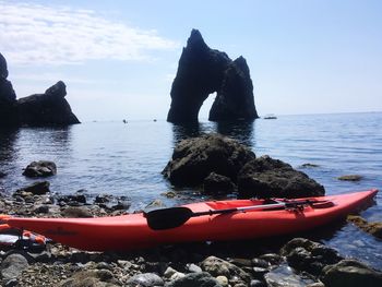 Scenic view of rocks on sea against sky