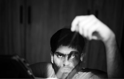 Portrait of young man looking away at home