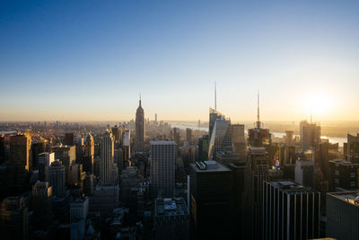 High angle view of cityscape against clear sky during sunset