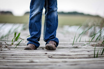 Low section of woman standing on ground