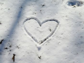 High angle view of heart shape on snow