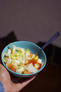 Close-up of person holding ice cream in bowl