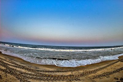 Scenic view of beach against clear sky