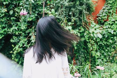 Rear view of woman on flower tree