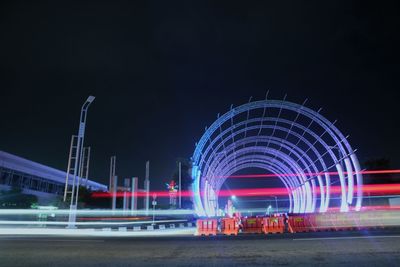 Illuminated light trails on road at night