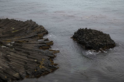 High angle view of rock formation in sea