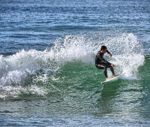 People surfing in sea