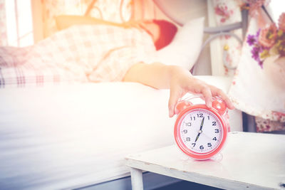 Midsection of woman on bed at home