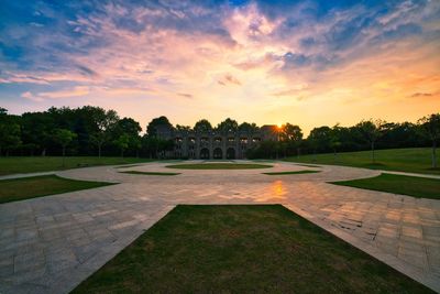 Footpath in park during sunset