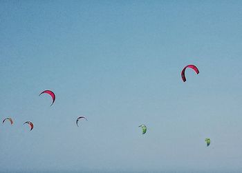 Low angle view of paragliding against clear sky