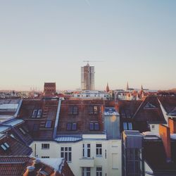 Buildings in city against clear sky