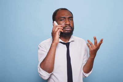 Portrait of young man using mobile phone