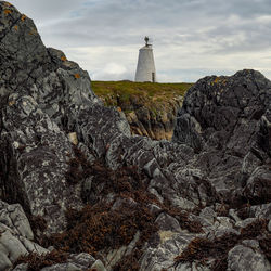 Lighthouse by rock formations
