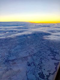 Scenic view of snowy field against sky during winter