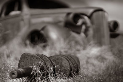 Close-up of abandoned truck on field