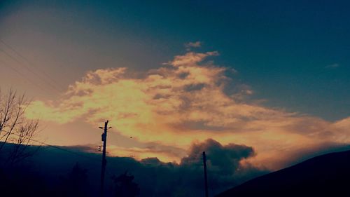 Low angle view of silhouette trees against sky