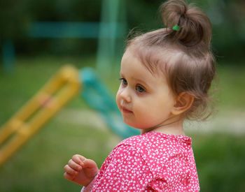 Close-up of cute girl looking away