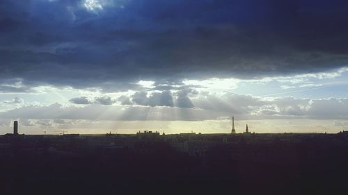 Silhouette cityscape against sky during sunset