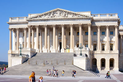 Group of people in front of historical building