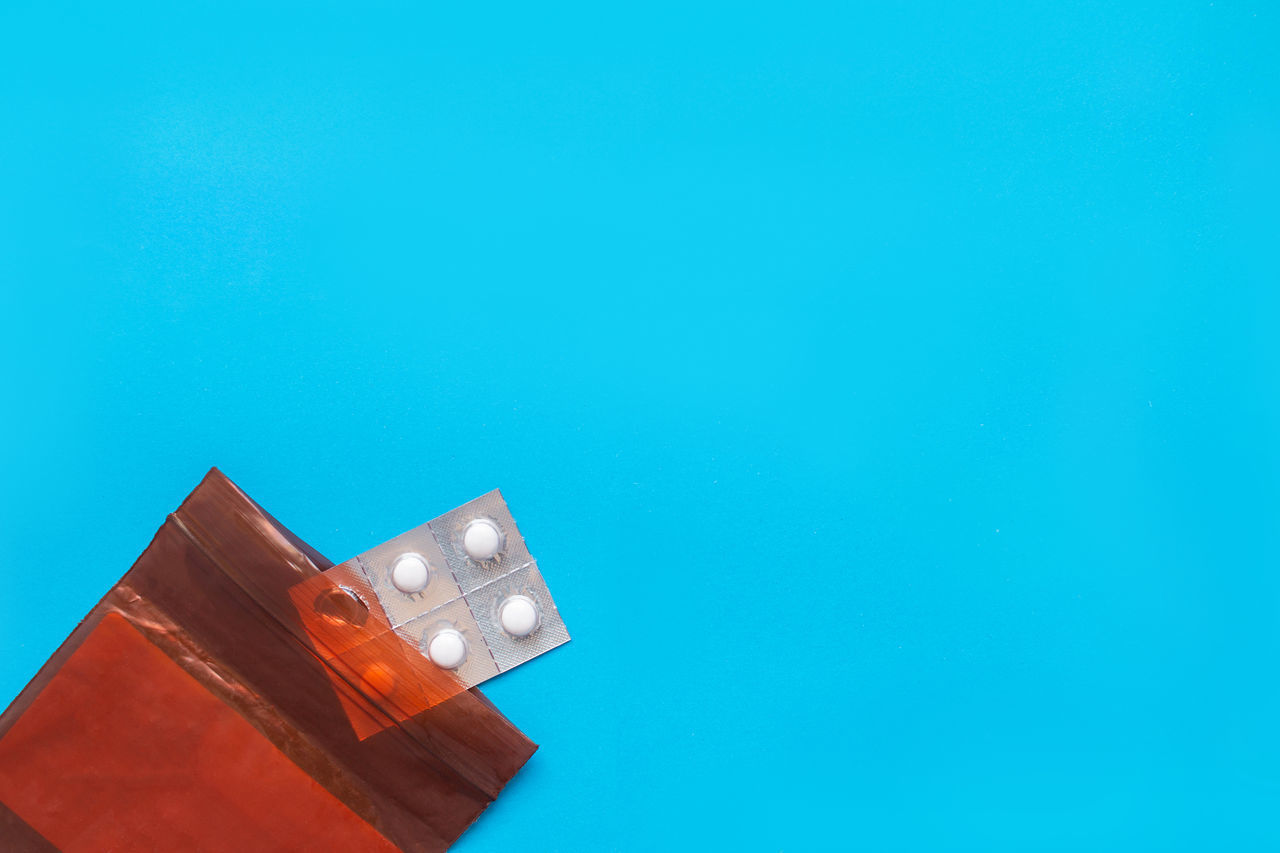 LOW ANGLE VIEW OF RED TOWER AGAINST BLUE SKY