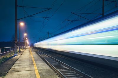 Blurred motion of train at railroad station platform