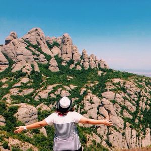 Full length of woman standing on cliff