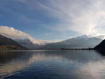 Scenic view of lake by mountains against sky