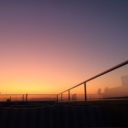 Silhouette bridge against clear sky during sunset