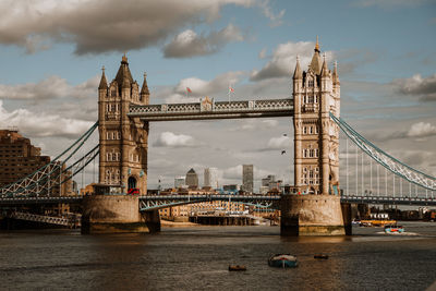 View of tower bridge over river against cloudy sky