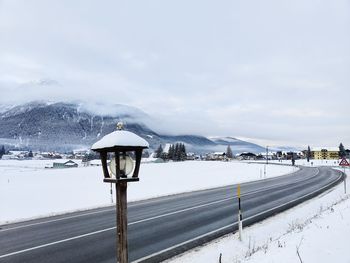 Street and lamp in snowy mountains