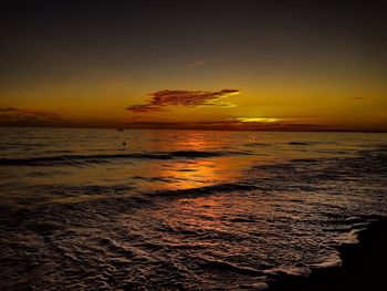 Scenic view of sea against romantic sky at sunset