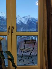 Scenic view of snowcapped mountains seen through window