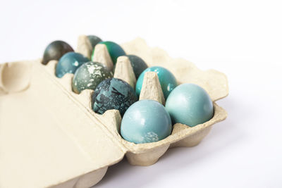 Close-up of multi colored easter eggs on white background