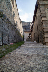 Narrow street amidst buildings against sky