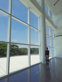 Rear view of man seen through glass window