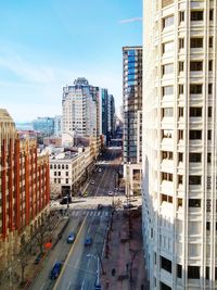 High angle view of street amidst buildings against sky