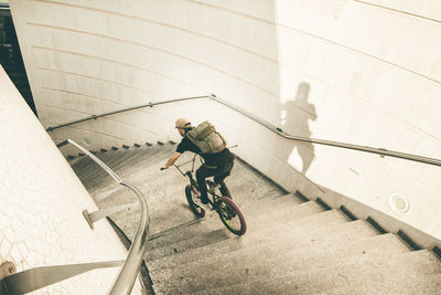Man riding bicycle on staircase