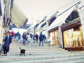 Low angle view of people walking on walkway