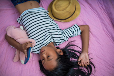 High angle view of girl lying on bed