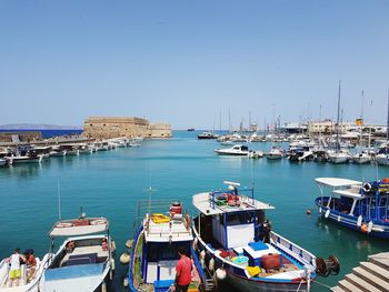 Boats moored at harbor