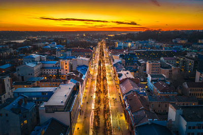 High angle view of illuminated cityscape against sky during sunset