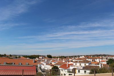 High angle view of houses against blue sky