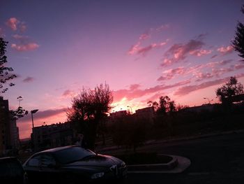 Cars on road at sunset