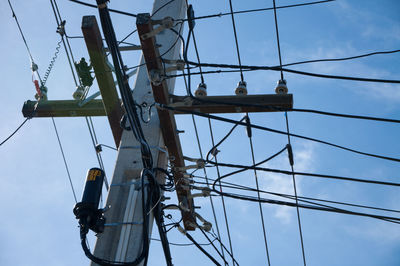 Low angle view of electricity pylon against sky